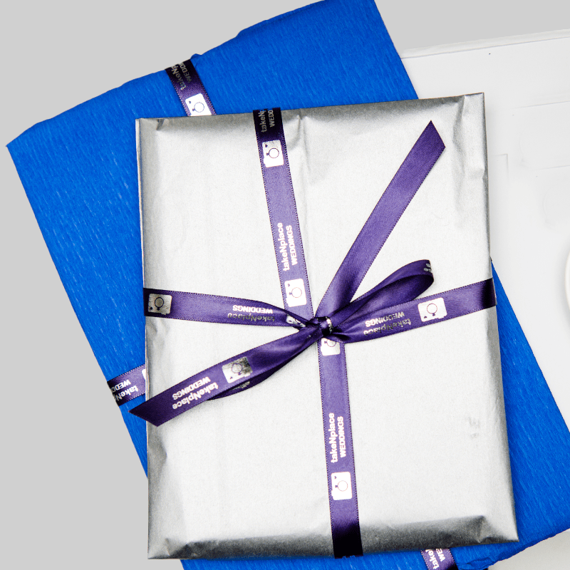 Wedding Qr codes wrapped in silver package with a purple takenplace ribbon surrounding